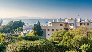 A coastal residential area with buildings, trees, and a view of the sea. - Apartment Grace by Interhome (Saint-Raphaël)