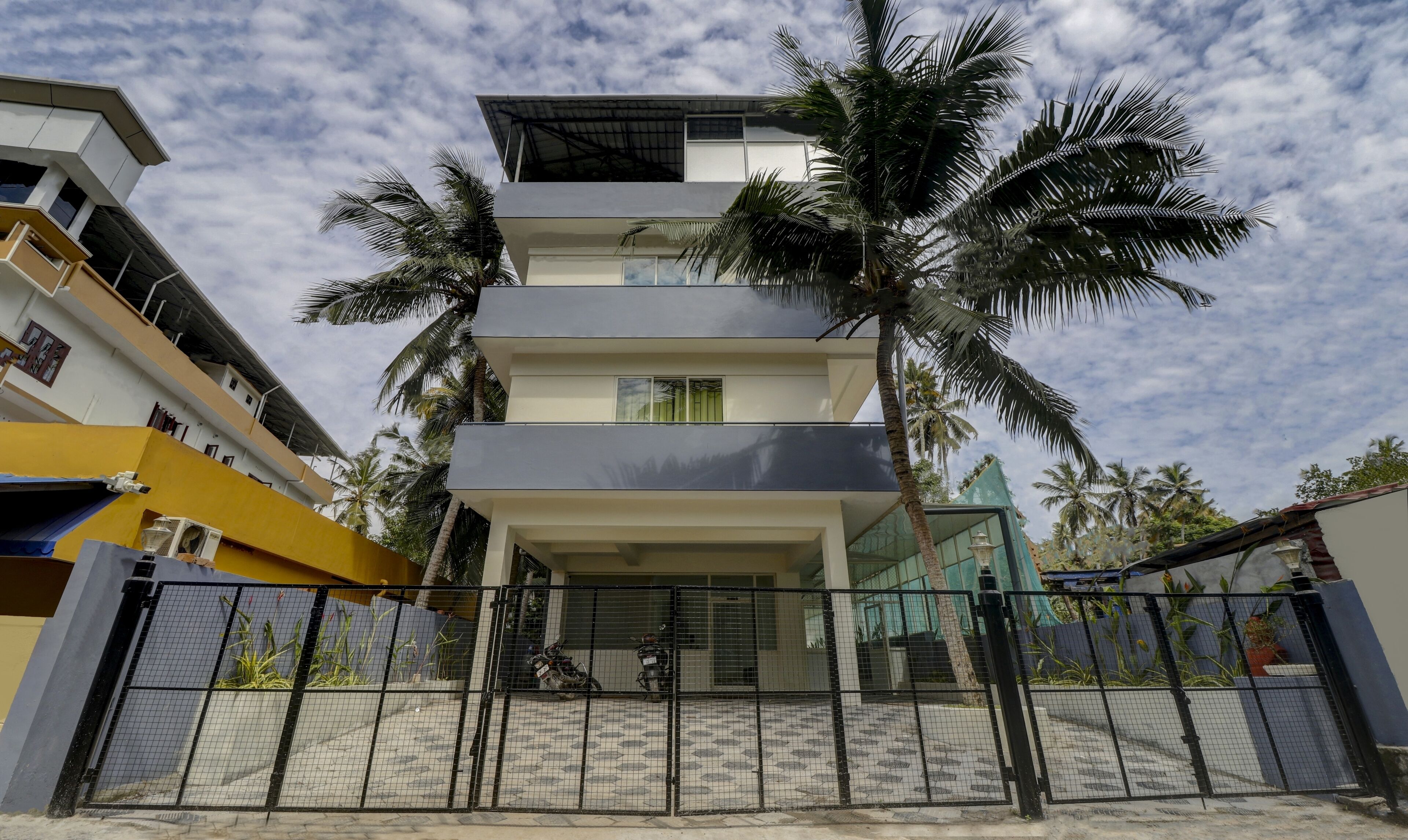 A multi-story building with a modern design, featuring balconies and large windows.