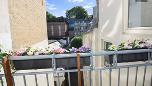 A balcony with flower boxes and a metal railing.