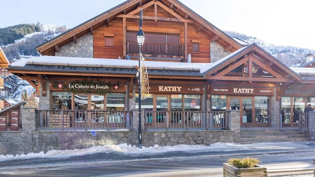A wooden building with a sign for 'La Cabote de Joseph' and 'KATHY' on the ground floor, featuring a stone facade and a balcony. - Duplex 3 rooms 6 ppl, terrace, garage, pets ok (Valloire)