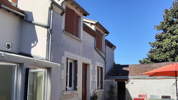 A two-story house with a patio area.