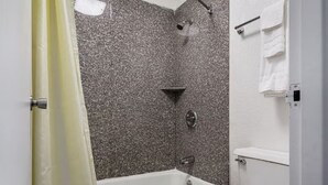 A bathroom with a bathtub, shower, and toilet. - Rodeway Inn Asheboro (Asheboro)