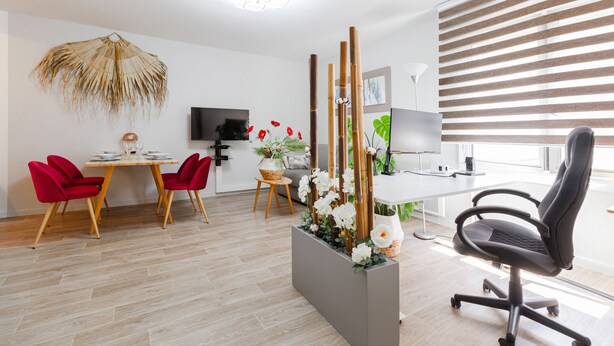 A modern dining area with a wooden table, red chairs, and a decorative plant arrangement. - Quiet 1-bed with office space, Saint-Cyprien, 200m to metro (Toulouse)