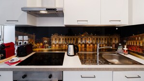 A modern kitchen with a large sink, a kettle, and a toaster. - Quiet 1-bed with office space, Saint-Cyprien, 200m to metro (Toulouse)
