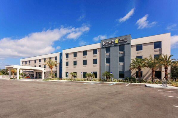 A modern hotel building with a sign reading "HOME 2 SUITES BY HILTON". - Home2 Suites by Hilton Vero Beach I-95 (Vero Beach)