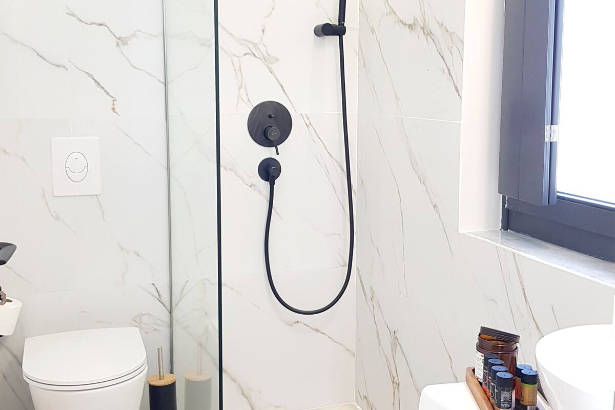 comfort studio suite | bathroom | shower, rainfall showerhead, hair dryer, slippers