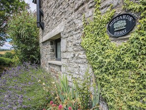 A stone building with a sign reading 'BUZZARDS BREG' and a window. - Buzzards Breg (Builth Wells)