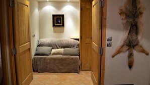 A room with a bed, a mounted fur piece, and wooden doors. - 1st floor, terrace, parking, tv, 60m², Saint Martin de Belleville (Saint-Martin-de-Belleville)
