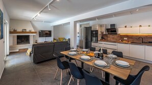 Una cocina moderna con comedor, electrodomésticos integrados y una zona de estar acogedora.