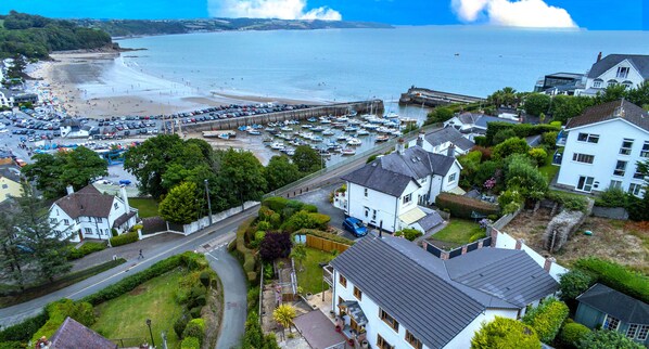 A coastal town with a marina, residential buildings, and a beach.