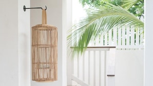 A staircase with a white railing and a woven basket hanging from the wall.