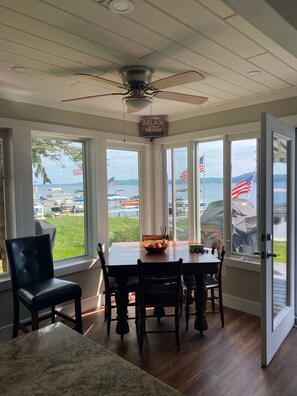 Un comedor con vista al lago, un ventilador de techo y un letrero que dice "RELAX YOU'RE AT THE LAKE".
