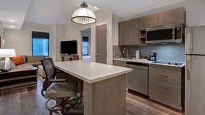 A modern kitchen with a central island, built-in microwave, and stainless steel appliances. - Hyatt House Mall Of America Msp Airport (Bloomington)
