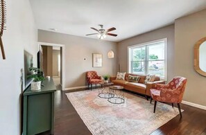 Relax in this inviting living room with a sofa, armchairs, and a coffee table.