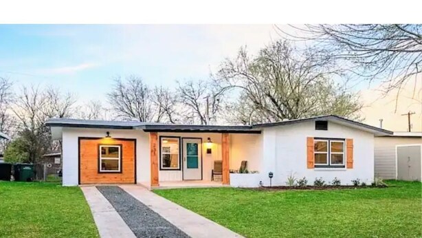 A modern single-story house with a front porch, a driveway, and a well-maintained lawn. - Join Us For A Fiesta! - Central San Antonio (San Antonio)