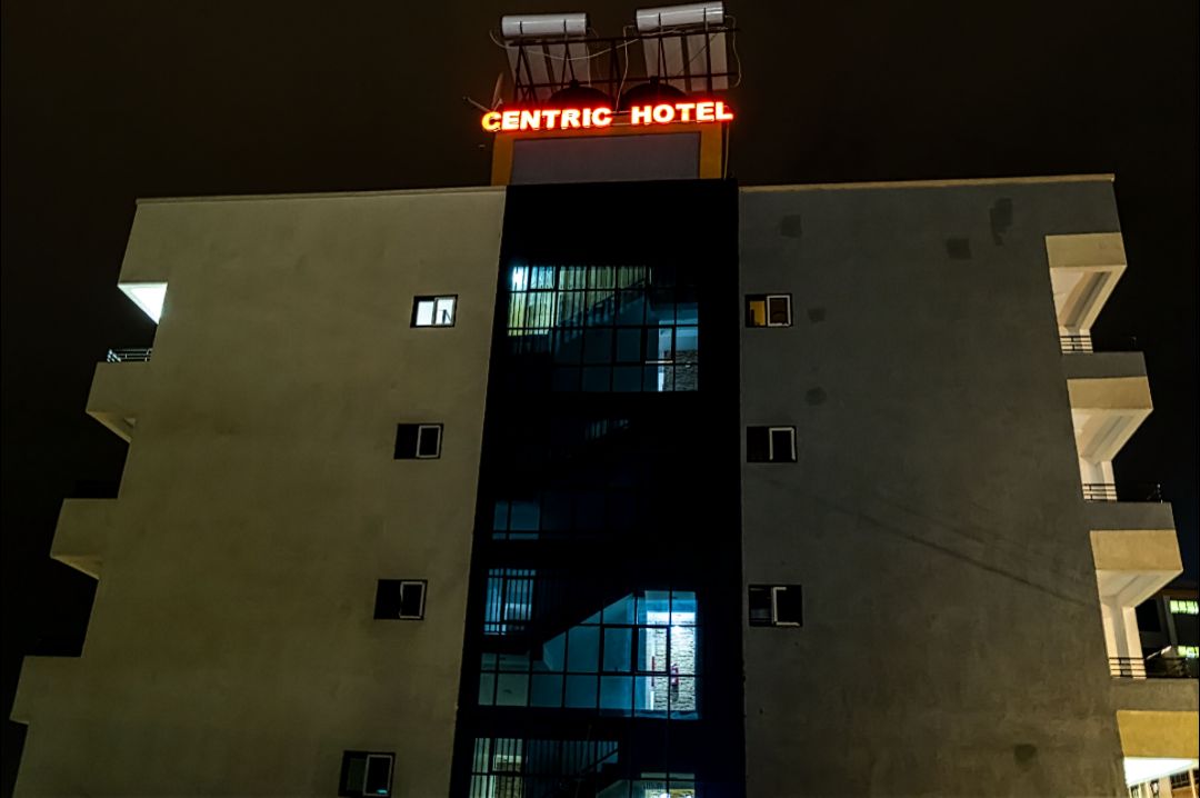 A building with a sign reading "CENTRIC HOTEL" at the top.