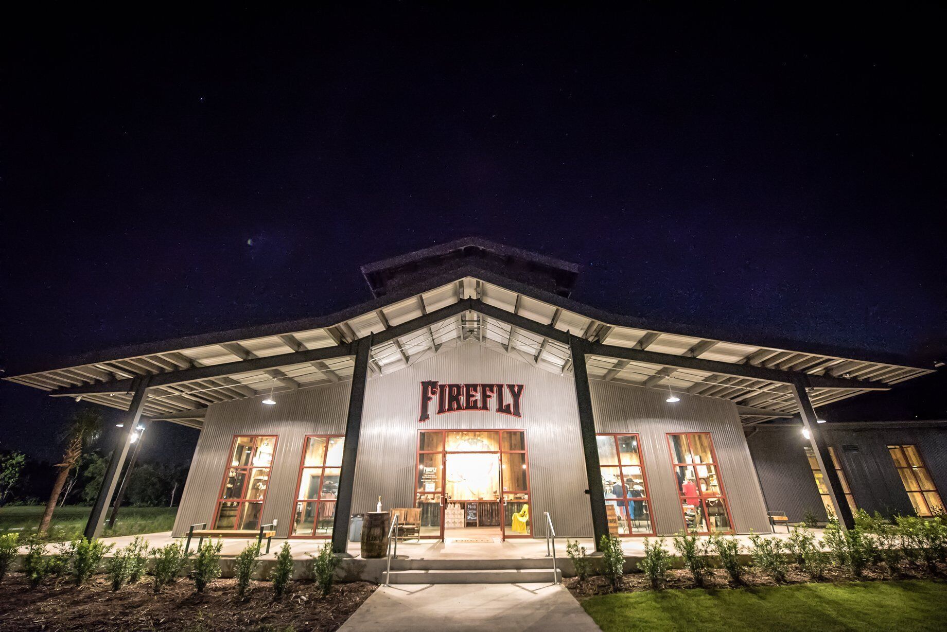 A building with a prominent 'Firefly' sign, large windows, and a covered entrance area.