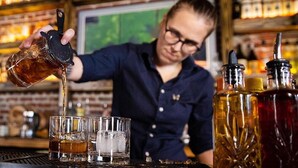 A bartender pouring a drink into a glass. - Covered patio, fenced back yard, open floor plan (North Charleston)