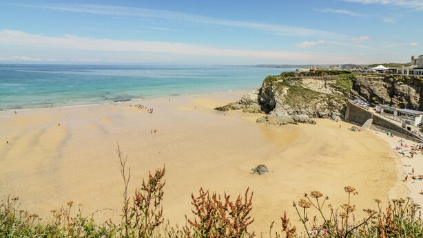 A beach with clear skies, a sandy shore, and rocky cliffs. - 30 Cliff Edge (Newquay)