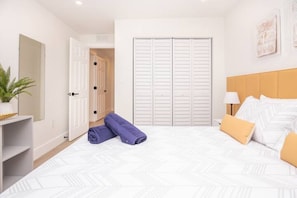 Relax in a stylishly designed room with a comfortable bed, a wooden headboard, and a wardrobe for your belongings.