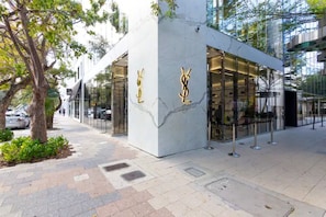 A modern building with a marble facade and glass entrance.