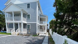 A two-story building with a porch and a white fence. - Sea La Vie Ocean City, steps away from the Beach & Boardwalk (Ocean City)