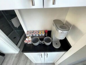 Fridge, microwave, coffee/tea maker, cookware/dishes/utensils