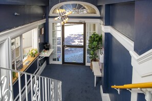 A staircase leading to a landing with a view of a snowy landscape. - Economy Double Room with Ensuite Bathroom (San Francisco)
