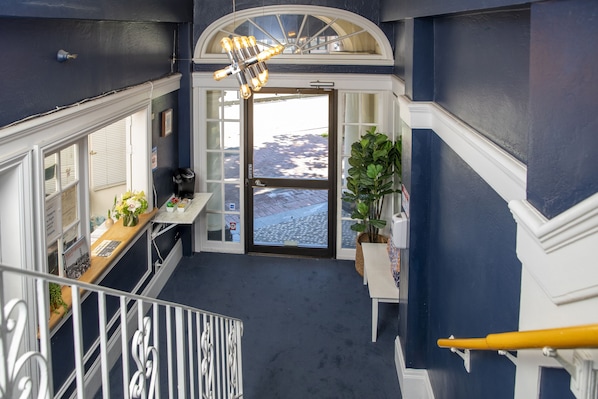 A staircase leading to a landing with a view of a snowy landscape.