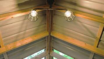 A corner of a room with metal walls and a wooden beam structure.