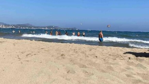 A beach with clear skies and waves.