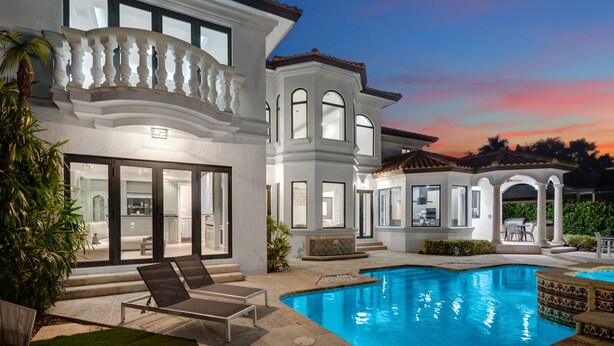 A large, modern house with a swimming pool, outdoor seating, and a patio area. - WATERFRONT MANSION (Fort Lauderdale)
