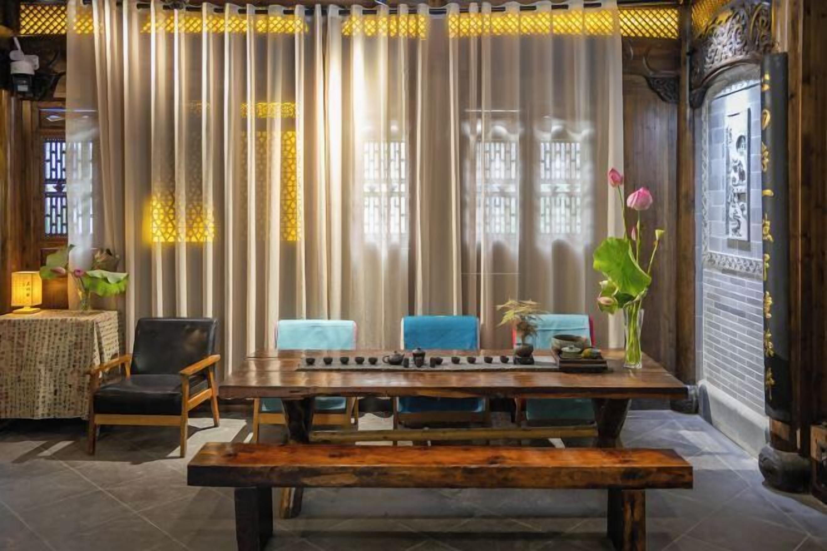 A traditional-style dining area with a wooden table, chairs, and a bench.