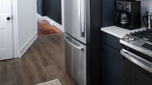 A kitchen with a refrigerator, oven, and coffee maker. - Brand New 4bd, 2ba Lancaster Center City Townhome (Lancaster)