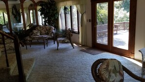 A cozy living room with a large window, a staircase, and a view of the outdoors. - Nestled near woods and creek, this large home is near state parks and colleges.. (Hillsboro)