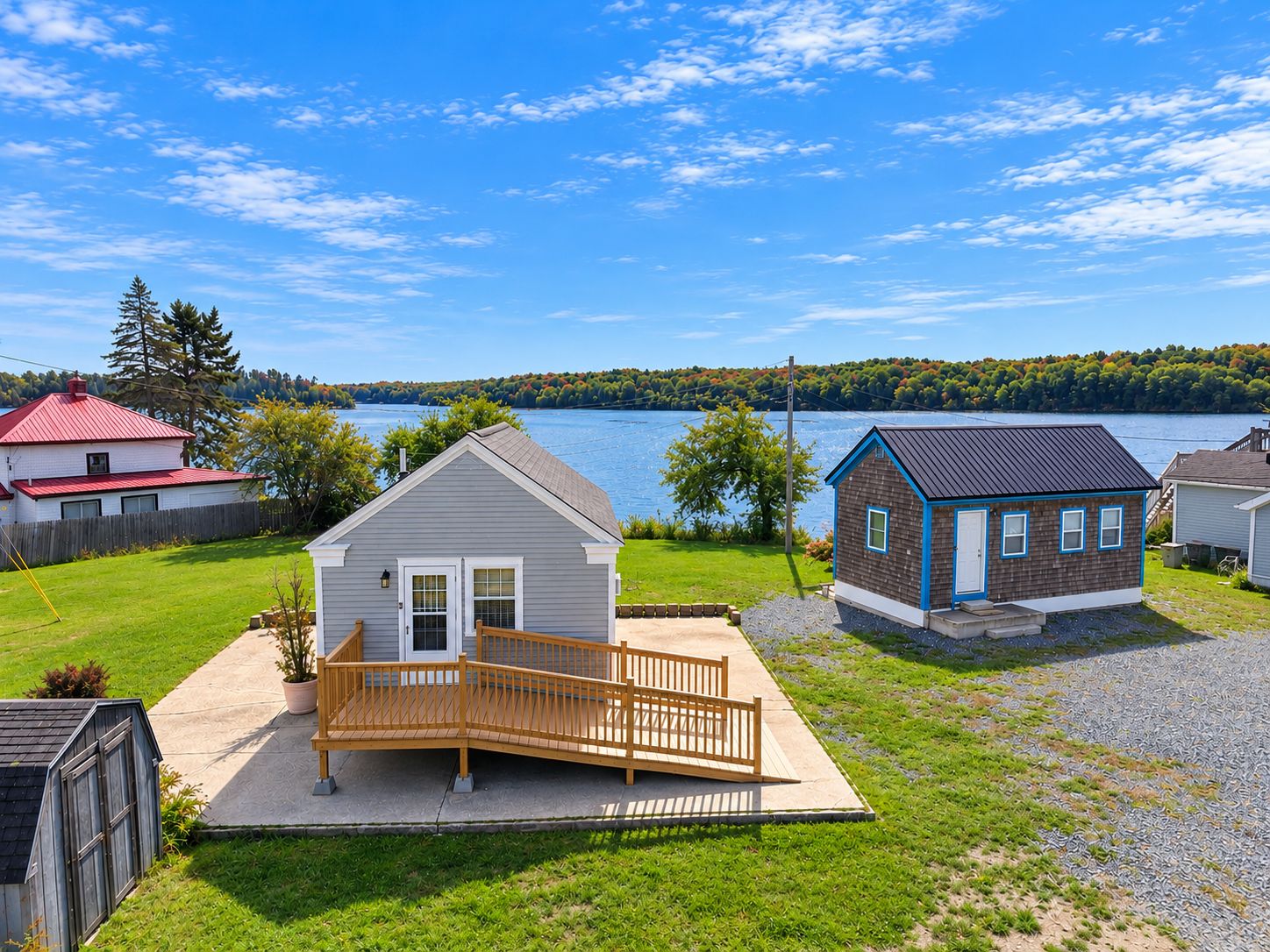 A residential area with a house featuring a porch and a small deck.