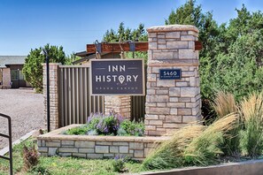 Welcome to Inn History Grand Canyon, located at 5460 N Sunset Strip, with a beautifully landscaped entrance.