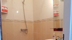 A bathroom with a toilet, shower, sink, and a mirror. - Nice T3 with terrace - MIXTA residence (Martil)