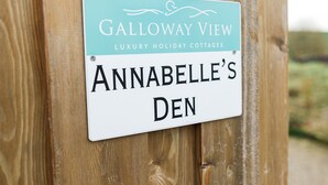 A sign for Galloway View Luxury Holiday Cottages, indicating the name of the property as Annabelle's Den.