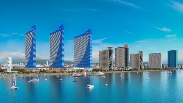 A waterfront cityscape with modern skyscrapers, including three prominent buildings with 'ORBI CITY' signage, and a marina with various boats.