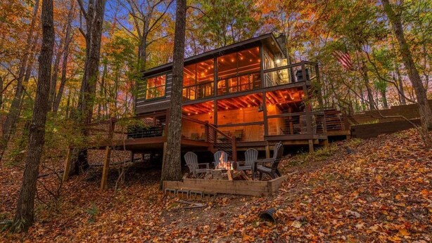 A cabin with a fire pit and outdoor seating, surrounded by trees. - Boho Bear Cave of Blue Ridge (Blue Ridge)