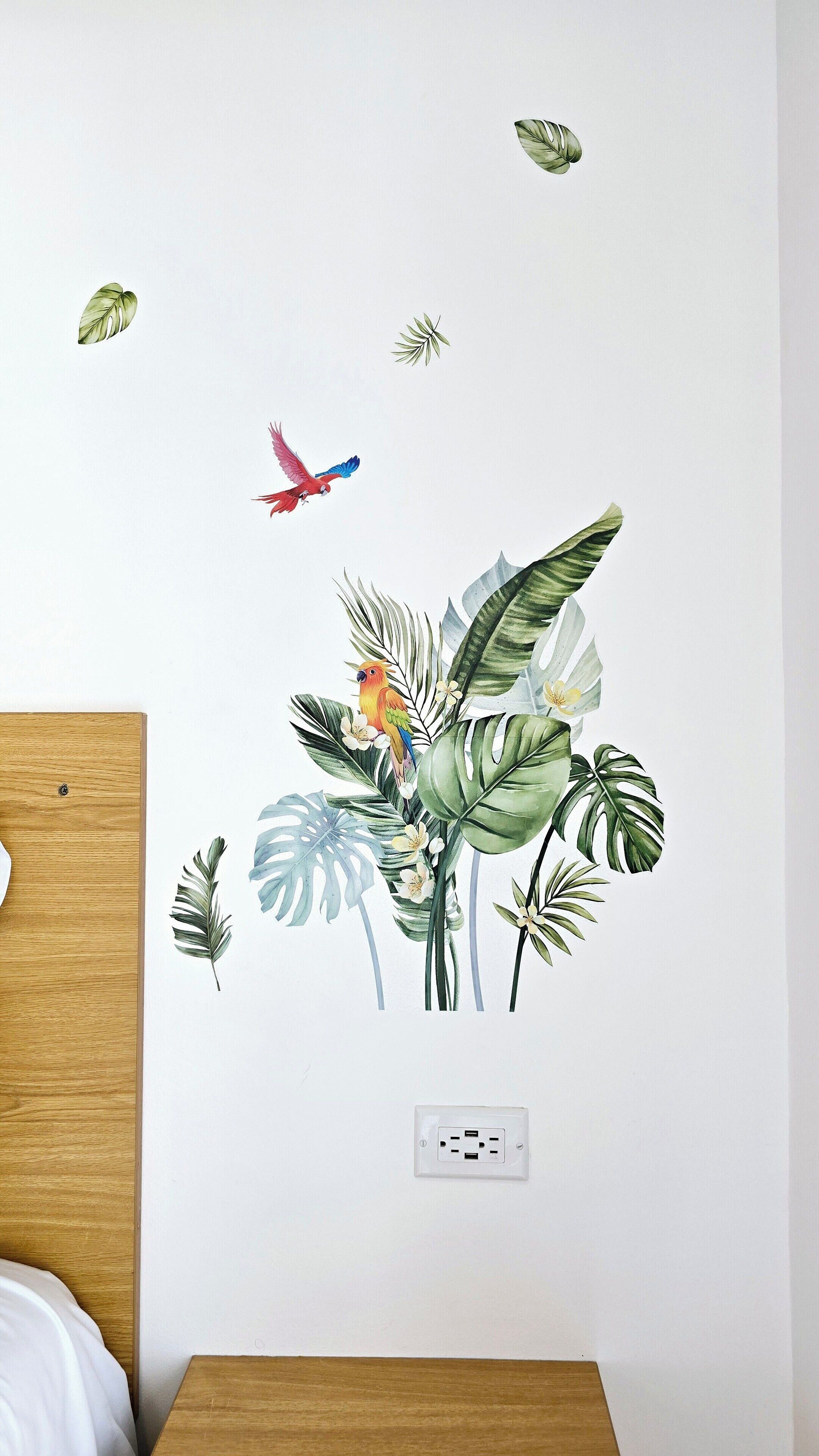 A wall with a nature-themed decal featuring birds and foliage.