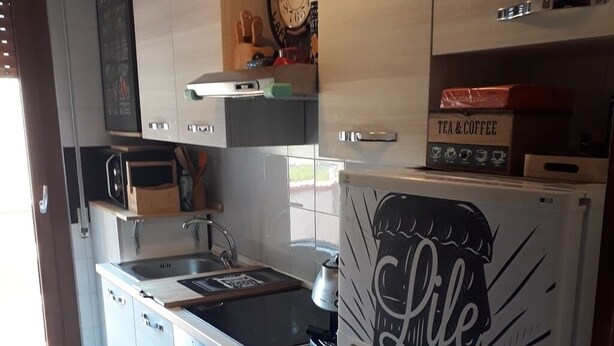 A modern kitchen with a refrigerator displaying the phrase "Life is Short, Make it Count." - Beach and relax. history and events. Everything at your fingertips. (Francavilla al Mare)