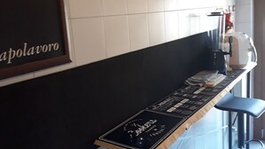 A restaurant interior with a long counter, black and white tiled walls, and a menu board. - Beach and relax. history and events. Everything at your fingertips. (Francavilla al Mare)