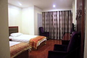 A hotel room with two beds, a desk, a chair, and a large window with curtains. - Shiji Zhixing Business Hotel (Fang County)