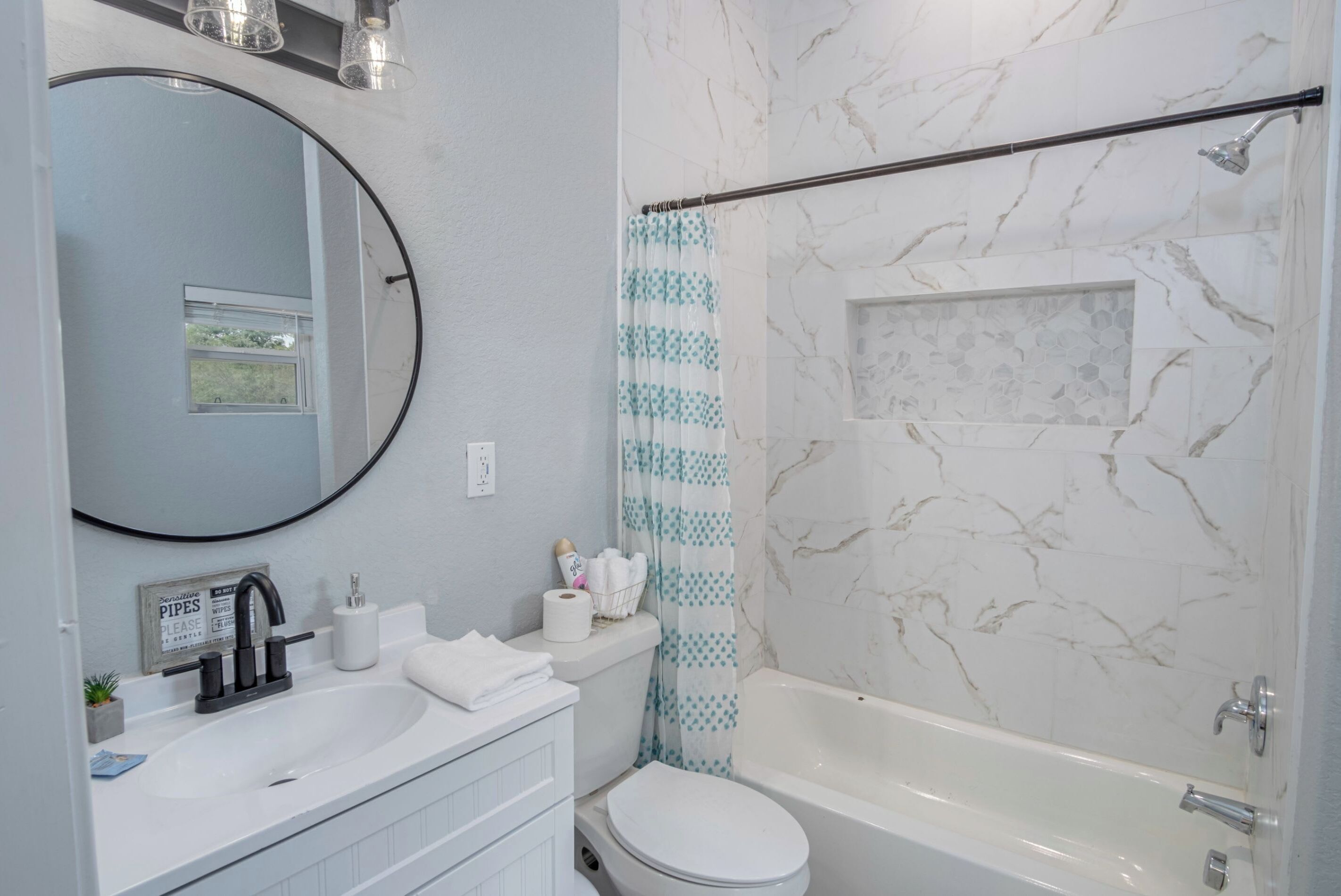 A bathroom with a sink, toilet, and bathtub.