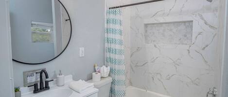 A bathroom with a sink, toilet, and bathtub.
