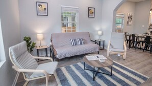 A modern living room with a sofa, two armchairs, a coffee table, and a dining area in the background. - Cozy and Lovely 2BR 2BA Apt#a Near Lively Downtown (San Antonio)