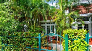 A gated entrance with a sign indicating the property number 13. - Pool + Walk to Duval & Fort Zachary | Monthly Stays | Key West Found (Key West)
