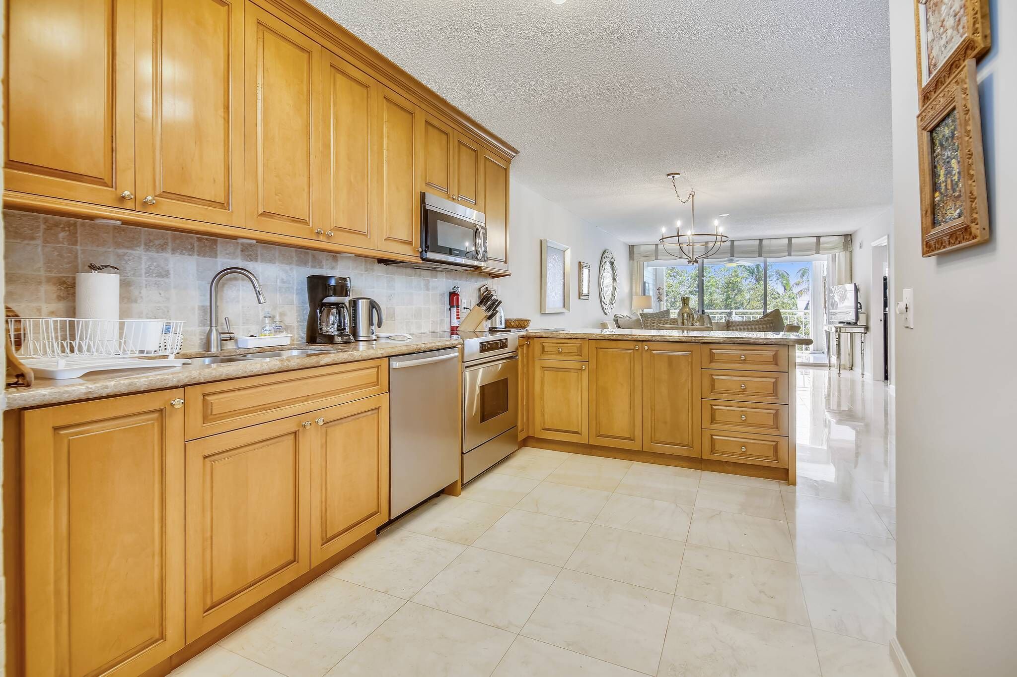 A spacious kitchen with wooden cabinets, stainless steel appliances, and a large island.